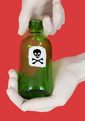 Image showing Green bottle with skull and crossbones