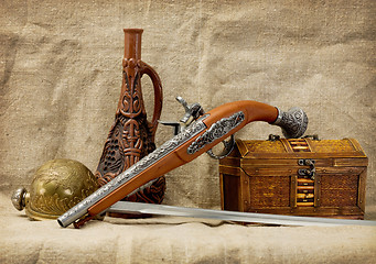 Image showing Pistol, bottle, rapier and trunk