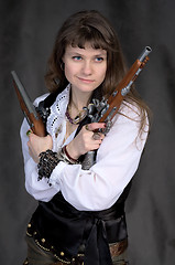 Image showing Girl - pirate with two ancient pistols in hands