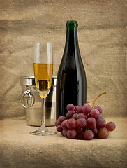 Image showing Glass of wine and a champagne bottle