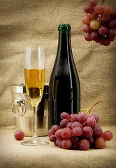 Image showing Champagne bottle, bucket, goblet and grapes