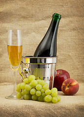 Image showing Still life with champagne bottle, goblet and fruits