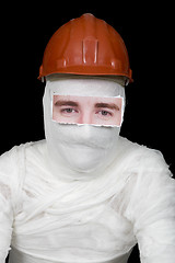 Image showing Bandaged man in helmet with false paper eyes