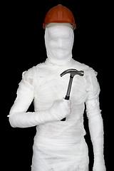 Image showing Laborer in bandages with helmet and hammer