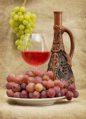 Image showing Ceramic bottle, grapes and red wine