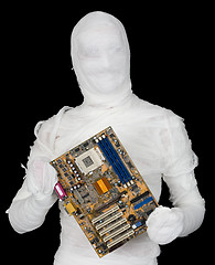 Image showing Bandaged man with motherboard