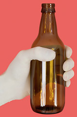 Image showing Brown bottle on hand