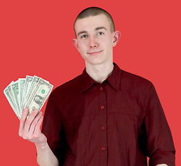 Image showing Young man with pack of dollars