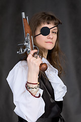 Image showing Girl - pirate with pistol in hand and eye patch