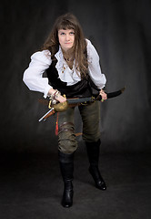 Image showing The girl - pirate with a sabre in hands