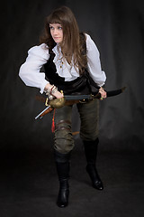 Image showing The girl - pirate with a sabre in hands