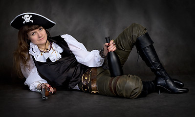 Image showing Girl - pirate with pistol and bottle