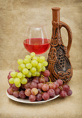 Image showing Ceramic bottle, grapes and red wine