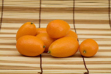 Image showing Fresh kumquat against a mat