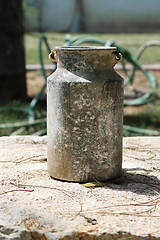 Image showing An old time milk jug