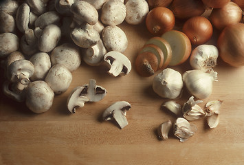 Image showing Mushrooms, onions and garlic on a butcherblock surface