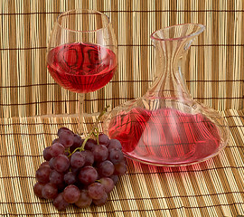 Image showing Stil life with decanter, goblet and grape