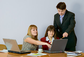 Image showing Girls at a desktop and their chief