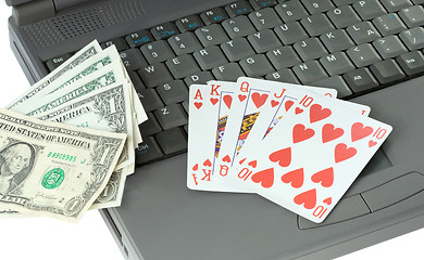 Image showing Laptop, playing cards and dollars