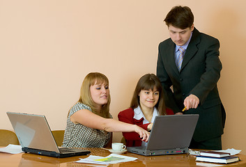 Image showing Girls at a desktop and their chief