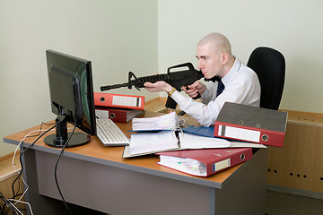 Image showing Clerk shoots from a rifle at the monitor