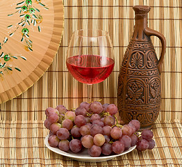 Image showing Bottle, bucket, goblet and grapes