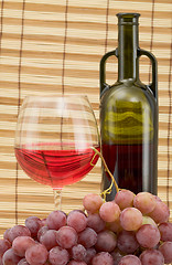 Image showing Glass bottle, goblet and grape