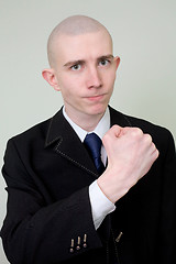 Image showing Man in a suit threatens with a fist