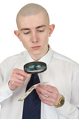 Image showing Man studying a counterfeit money