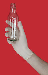 Image showing Empty glass bottle on the male hand