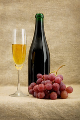 Image showing Champagne bottle, goblet, grapes