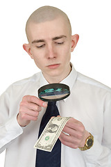 Image showing Man studying a counterfeit money