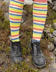 Image showing Amusing striped feet in boots