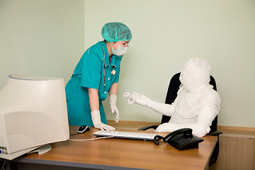 Image showing The bandaged boss and nurse