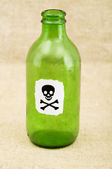 Image showing Green bottle with sticker skull and crossbones