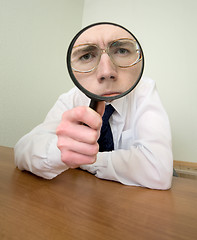 Image showing Man with a magnifier in a hand