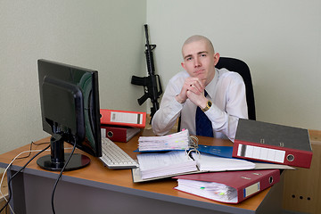 Image showing Chief on a workplace with a rifle on a background