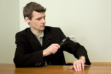 Image showing Person view a watch through a magnifier