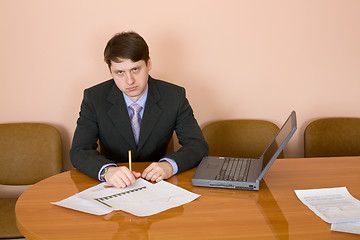 Image showing Businessman at a table with laptop