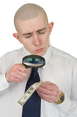 Image showing Man studying a counterfeit money