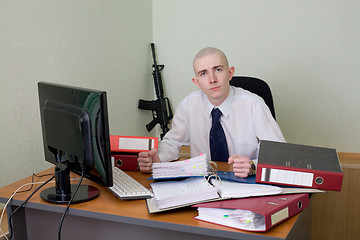 Image showing Chief on a workplace with a rifle on a background