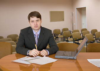 Image showing Businessman at a table with laptop