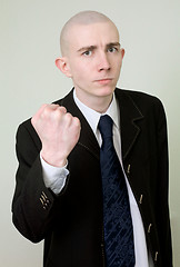 Image showing Man in a suit threatens with a fist