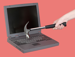 Image showing Laptop and hand with hammer