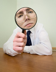 Image showing Man with a magnifier in a hand