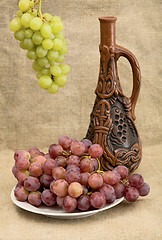 Image showing Ceramic bottle and grapes 