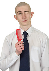 Image showing Absolutely bald guy with a hairbrush