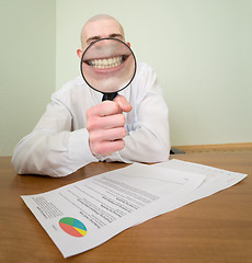 Image showing Guy looks through the big magnifier