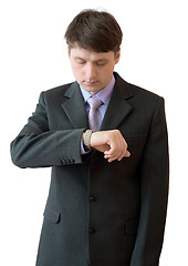 Image showing Young man looks at a watch