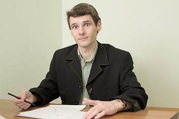 Image showing Clerk at office sits at a desktop